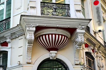 beautiful decorative corner balcony with wrought iron railing and stone piers. round shaped...