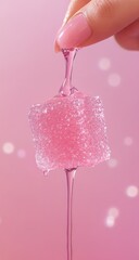 Pink, sugary cube candy being drizzled