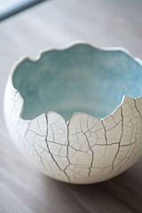 Cracked ceramic bowl, pale cream, light teal interior
