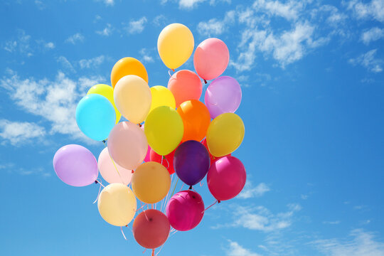 Many colorful air balloons on cloudy sky background
