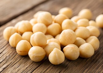 Close-up of premium, raw macadamia nuts scattered on a rustic wooden surface, with soft natural lighting highlighting their smooth