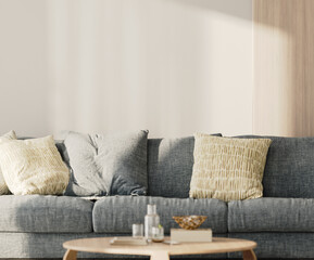 Close-up of a white empty wall in living room with blue sofa and table with decor, 3d render