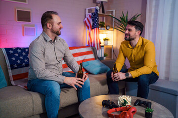 Friends enjoy drinks and conversation in cozy living room setting