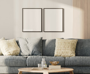 Two blank frames mock-up on a white wall with wooden panel above blue sofa in living room, 3d render