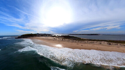 Newcastle Nobbys Beach NSW Australia Aerial View of Coastal Beach and Ocean Under Blue Sky and Rolling Waves