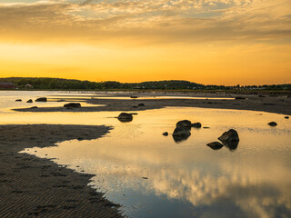 Evening light casts golden reflections on coastal waters in Sweden