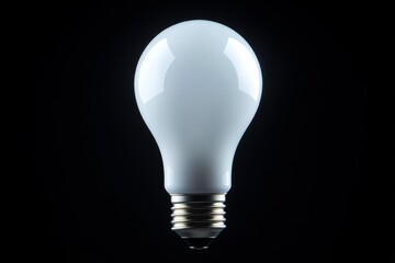 Light bulb standing out against a black background, representing ideas, innovation, and solutions