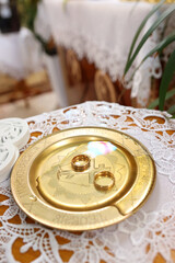 Wedding gold rings on a tray. Wedding ceremony.