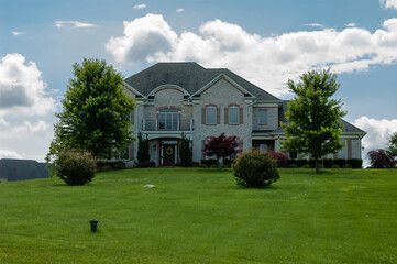 Gorgeous landscape with a single family house with a lawn. House in the suburbs