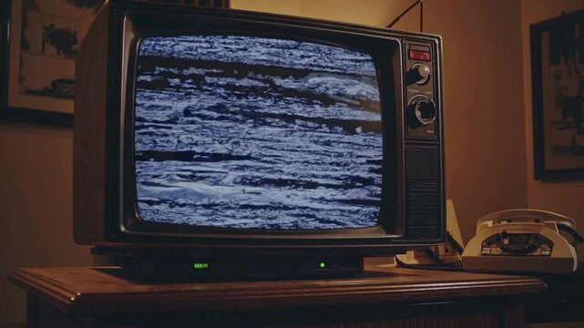 Vintage Television Static: A retro television set displaying a snowy static screen evokes a sense of nostalgia and technological obsolescence.
