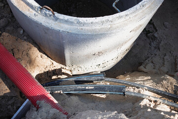 Construction site with excavation work and plumbing materials being used during daylight hours