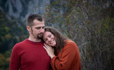 Fototapeta premium happy young couple posing outdoors in autumn