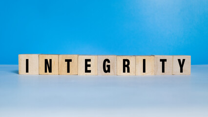 integrity word text on wooden blocks on blue background