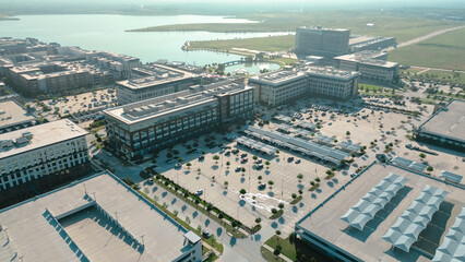 Lakeside canopy structures shade coverage parked vehicles at suburban business district, residential hub in master planned Cypress Waters, Dallas Fort Worth, commercial buildings, office, retail
