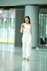 Fototapeta premium She is looking at the screen of the phone