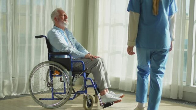 Help support retirement healthcare. Nurse helping old man in wheelchair. Patient and woman in nursing home for medical caregiver. Nurse taking care of paralyzed man in chair for people with disability