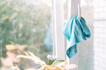 Detail of a damp microfiber cloth placed on a wet surface, bubbles and water drops visible around. High quality photo