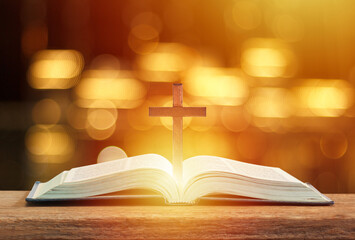 Christian wooden cross on open bible, Holy concept