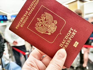 Russian passport held while preparing for international travel at customs before crossing the border