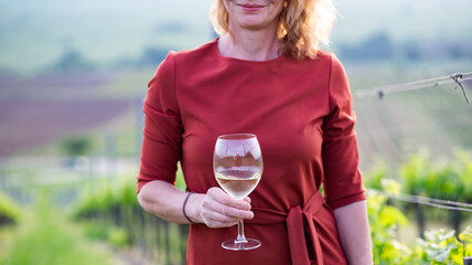 happy woman tasting wine in a vineyard
