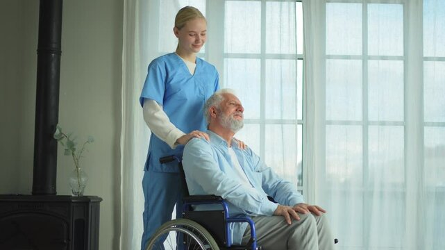 Help support retirement healthcare. Nurse helping old man in wheelchair. Patient and woman in nursing home for medical caregiver. Nurse taking care of paralyzed man in chair for people with disability