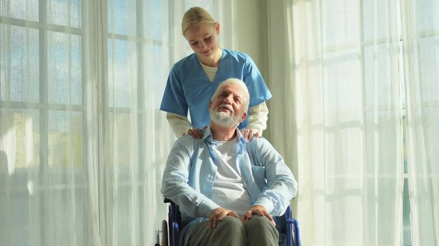 Help support retirement healthcare. Nurse helping old man in wheelchair. Patient and woman in nursing home for medical caregiver. Nurse taking care of paralyzed man in chair for people with disability