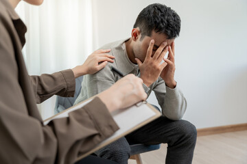 psychiatrist holds shoulders while discussing life and family issues. doctor encourages and empathy...