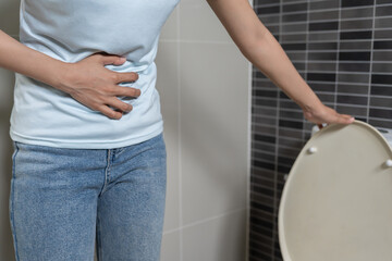 Constipation and diarrhea in bathroom. Hurt woman touch belly  stomach ache painful. colon...