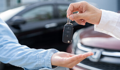 lease, rental car, sell, buy. Dealership manager send car keys to the new owner.  Sales, loan credit financial, rent vehicle, insurance,  renting, Seller, dealer, installment, car care business