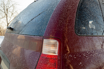 In the morning the car was covered with a thin layer of snow. Frost on the rear door windows
