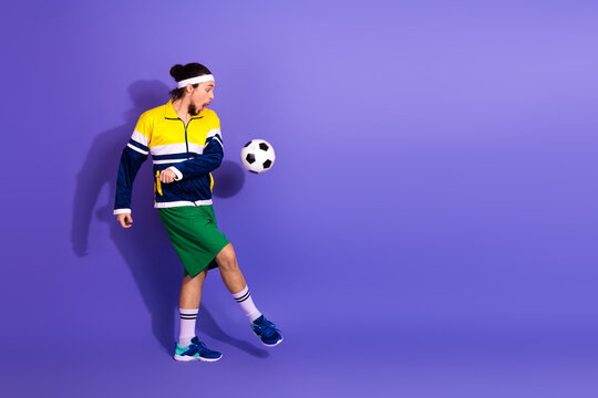 Male athlete in colorful sportswear juggling a soccer ball against a vibrant violet background - Powered by Adobe