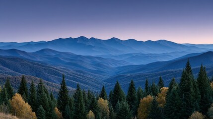 Obraz premium A vista of layered mountains bathed in the soft light of dawn.