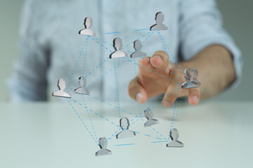 Image of a hand interacting with a network of people, symbolizing teamwork, collaboration, and...