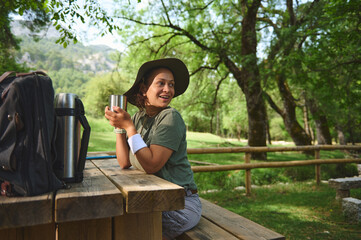 Fototapeta premium Woman Enjoying Outdoor Camp in Scenic Wooded Area