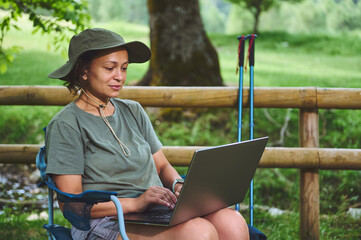 Woman Enjoying a Digital Nomad Lifestyle Outdoors While Working Remotely