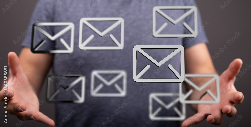 Poster image of a man holding multiple email icons, representing communication, inbox, messages.