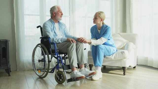 Help support retirement healthcare. Nurse helping old man in wheelchair. Patient and woman in nursing home for medical caregiver. Nurse taking care of paralyzed man in chair for people with disability