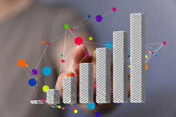 Hand interacting with a 3D bar graph showing upward trend and data connections.