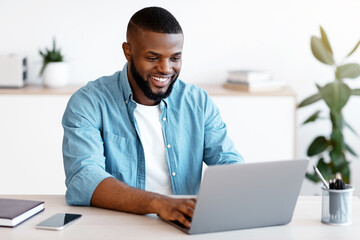 Distance Job. Millennial African American Man Working Online On Computer At Home Office, Handsome...