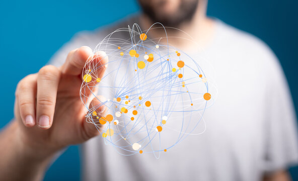Stock photo of a person interacting with a digital network graphic, representing connection and data visualization. - Powered by Adobe