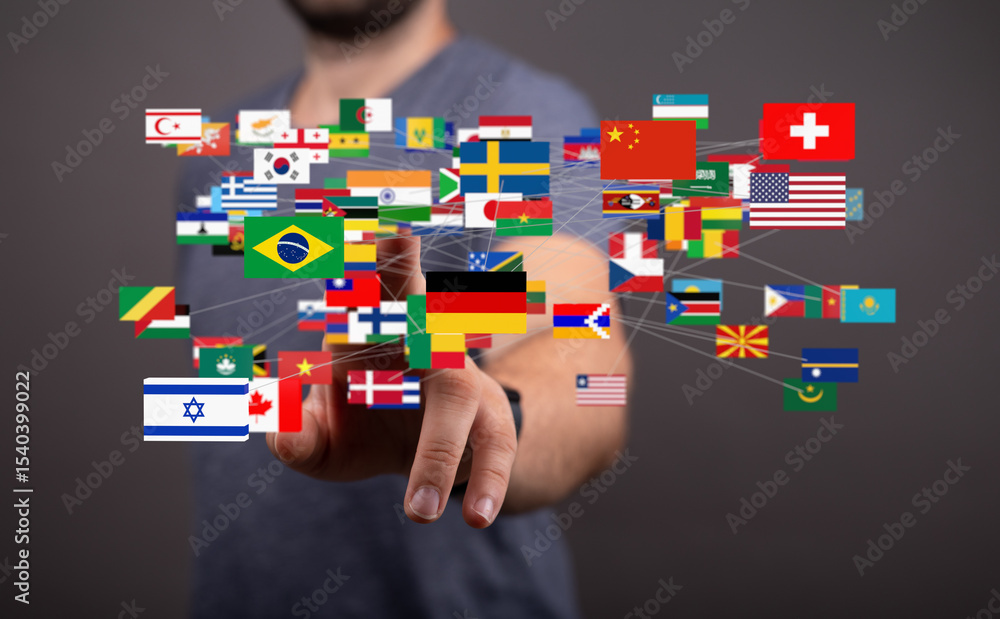 Poster man interacts with a digital network of flags representing global connectivity and international rel