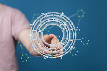 Person interacting with a futuristic digital interface showing data analysis and visualization.