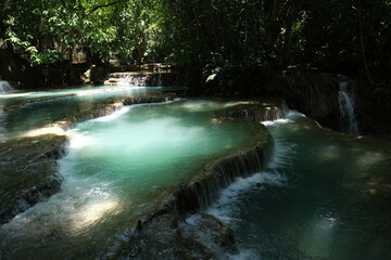A beautiful waterfall with a stream of water flowing down it