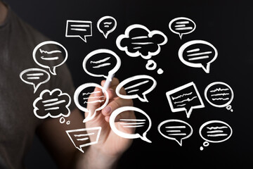 Abstract image of hand drawing speech bubbles on a blackboard.  Perfect for communication,...