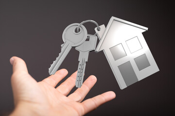 Image of house keys on an open hand, symbolizing new home ownership and real estate.