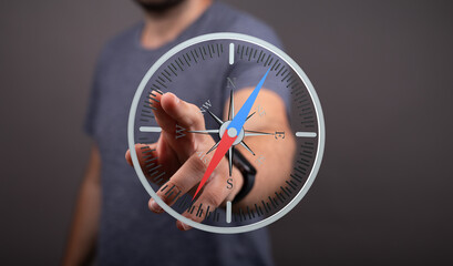 A man interacts with a digital compass, symbolizing guidance, direction, and strategic planning.
