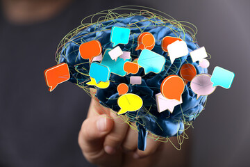 Abstract image of a brain with colorful speech bubbles, symbolizing communication, ideas, and...