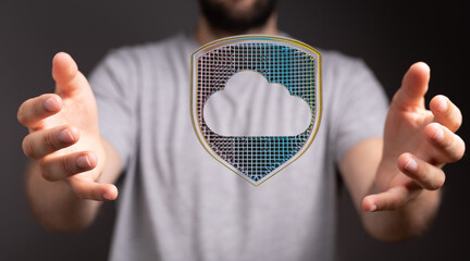 Image depicts hands protecting a digital cloud with a shield, symbolizing secure cloud storage and...