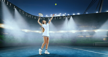 Woman tennis player playing tennis on professional tennis stadium in night.