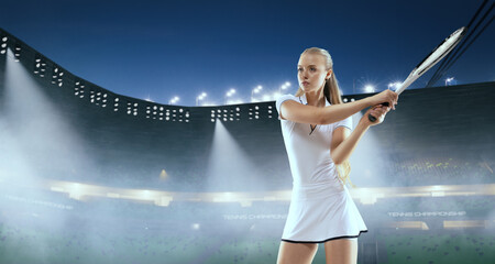 Woman tennis player playing tennis on professional tennis stadium in night.